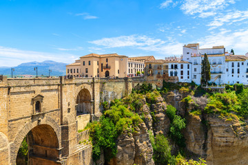 Famous bridge and white houses in Ronda village in spring, Andalusia, Spain - obrazy, fototapety, plakaty