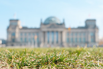 Berlin Reichstag defocused behind meadow -  German Bundestag, government building  
