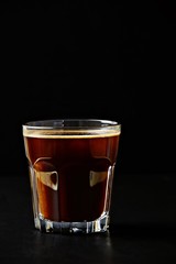 Black coffee glass isolated on dark