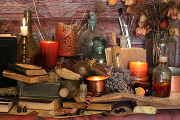 Antique Magic Book. Witchcraft Peacock feathers and candle background. Black candle Magic Ritual.