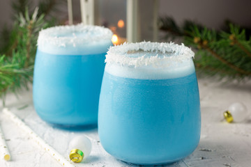Blue curacao Christmas Cocktail on Christmas decorated holiday table © juliamikhaylova