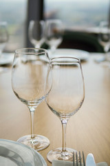 Wine glasses and plates on the table in restraint