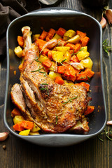 baked turkey thigh with vegetables.