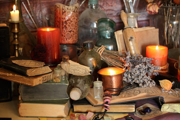 Antique Magic Book. Witchcraft Peacock feathers and candle background. Black candle Magic Ritual.