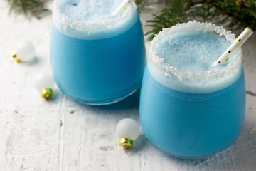 Blue curacao Christmas Cocktail on Christmas decorated holiday table