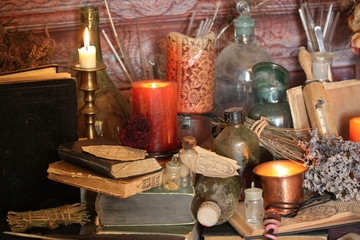 Antique Magic Book. Witchcraft Peacock feathers and candle background. Black candle Magic Ritual.