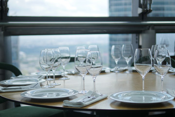 Wine glasses and plates on the table in restraint