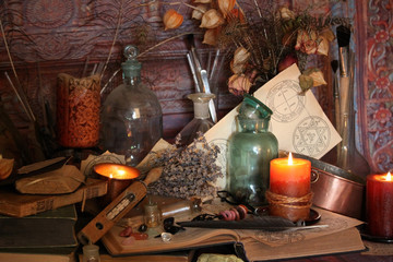 Antique Magic Book. Witchcraft Peacock feathers and candle background. Black candle Magic Ritual.