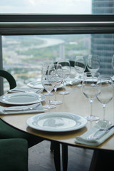Wine glasses and plates on the table in restraint