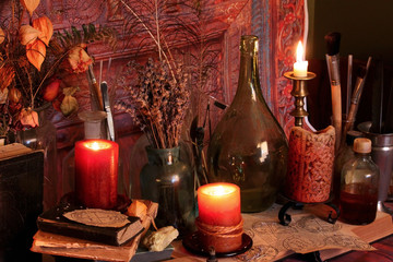 Antique Magic Book. Witchcraft Peacock feathers and candle background. Black candle Magic Ritual.