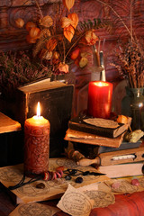 Antique Magic Book. Witchcraft Peacock feathers and candle background. Black candle Magic Ritual.