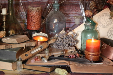 Antique Magic Book. Witchcraft Peacock feathers and candle background. Black candle Magic Ritual.