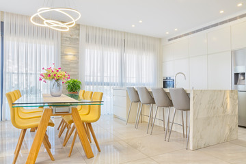 Luxury White Kitchen With Marble Island And Dinner Table
