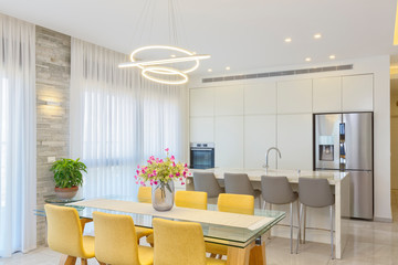 Luxury White Kitchen With Marble Island And Dinner Table