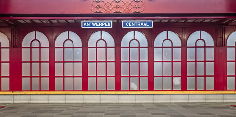 Image of "Antwerpen Centraal" name sign against red iron background