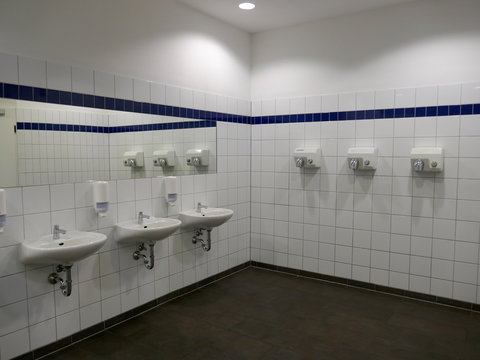 Modern wash room and sanitary facilities in a public building, Germany, Europe.
Interior of public clean wash room in shared toilet there is a wide selection of sinks with mirrors and clean toilets