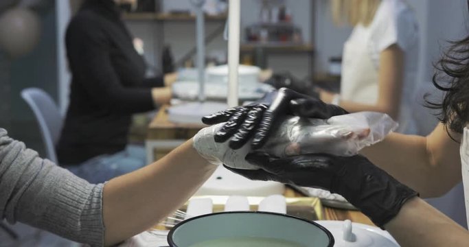 Two beauticians with two customers