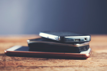 Blank screen smartphones on wooden background