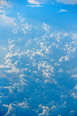 Fototapeta na wymiar Flight over clouds. Wonderful panorama from window of plane with white clouds