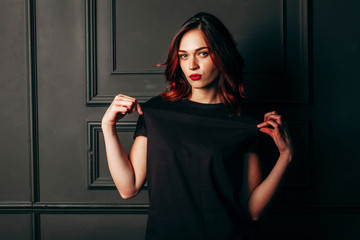 Portrait of young woman wearing blue jeans and black t-shirt