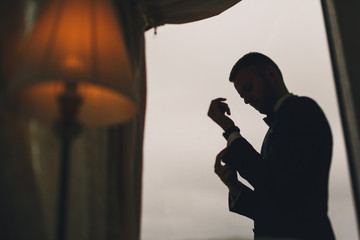 elegant groom in a hotel room