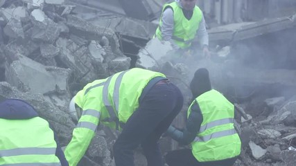 a group of rescue workers dismantle the rubble of the destroyed house after the earthquake close up