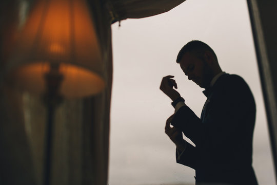elegant groom in a hotel room