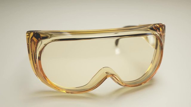 A pair of safety goggles on a white desk. Scientific eyes protection equipment.
