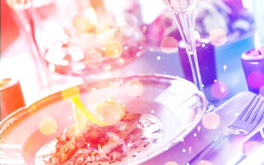 Close-up of Table with Food, Plates, Candles and Champagne