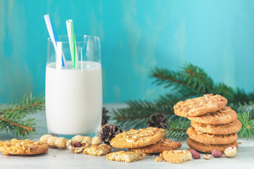 Christmas and New Year composition with delicious peanut cookies, peanuts and glass of milk