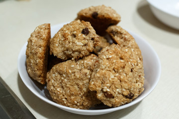 Homemade oatmeal cookies in white bowl on the table in landscape format