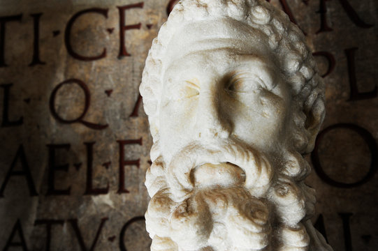 Bust of imperator Commodus in the Capitoline Museum in Rome. On the background ancient latin inscription. Rome, Italy