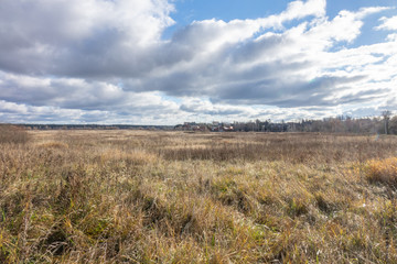 landscape with autumn field and blue sky