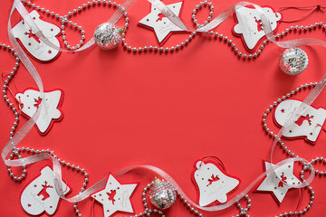 Fototapeta na wymiar Christmas composition, mockup on red background. Christmas white and silver ribbon, garlands, toys border with copy space. Flat lay, top view