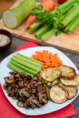 Vegan diet food. Fried mushrooms with celery, carrots and zucchini.