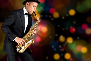 Fototapeta na wymiar Close-up man playing on saxophone on background