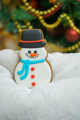 Cake snowman with a hat during Christmas time with Christmas Eve  on the background