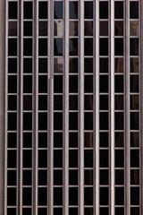 Modern glass windows in concrete building facade - urban modern architecture