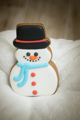 Cake snowman with a hat during Christmas time with Christmas Eve  on the background