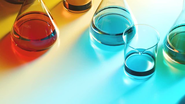 Colorful liquids in laboratory glassware. Beakers and flasks in the lab.