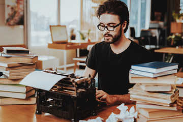 Concept of Young Guy Working on Typewriter
