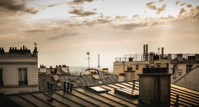 View of the Eiffel Tower above the rooftops of Paris