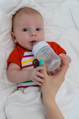 Baby infant drinks bottle milk formula, bottle-feeding