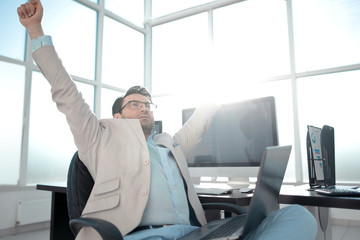 Fototapeta premium yawning businessman sitting in front of the Desk.