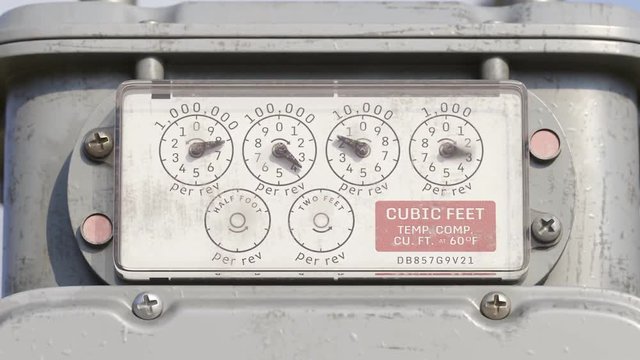 Zoom in on weathered gas meter dials measuring cubic feet