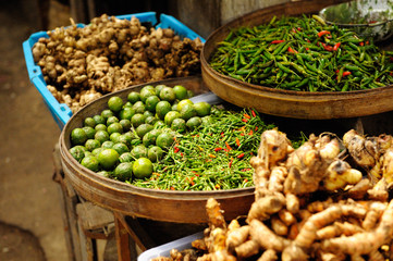 Chili, lemons and galangal displayed in bamboo baskets at market place in Bali.