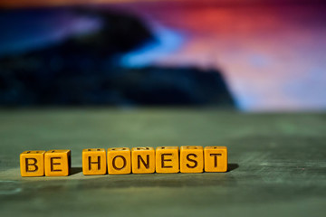 Be honest on wooden blocks. Cross processed image with bokeh background