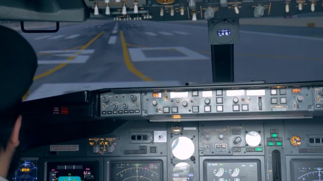 A person goes on a runway in a flight simulator, close up.