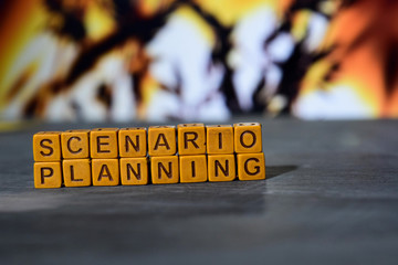 Scenario planning on wooden blocks. Cross processed image with bokeh background