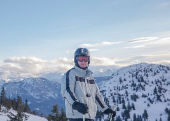 Fototapeta na wymiar European male skier using action camera on top of mountain 